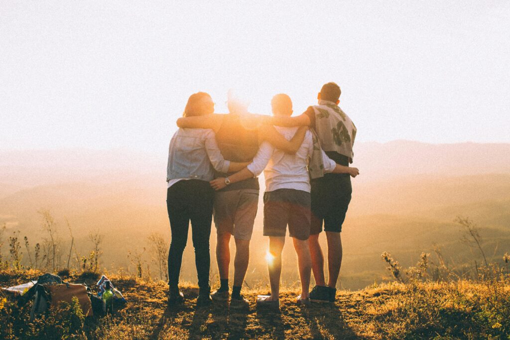 pexels photo 697243 697243 A group of friends embrace while enjoying a breathtaking sunrise over the Brazilian highlands.